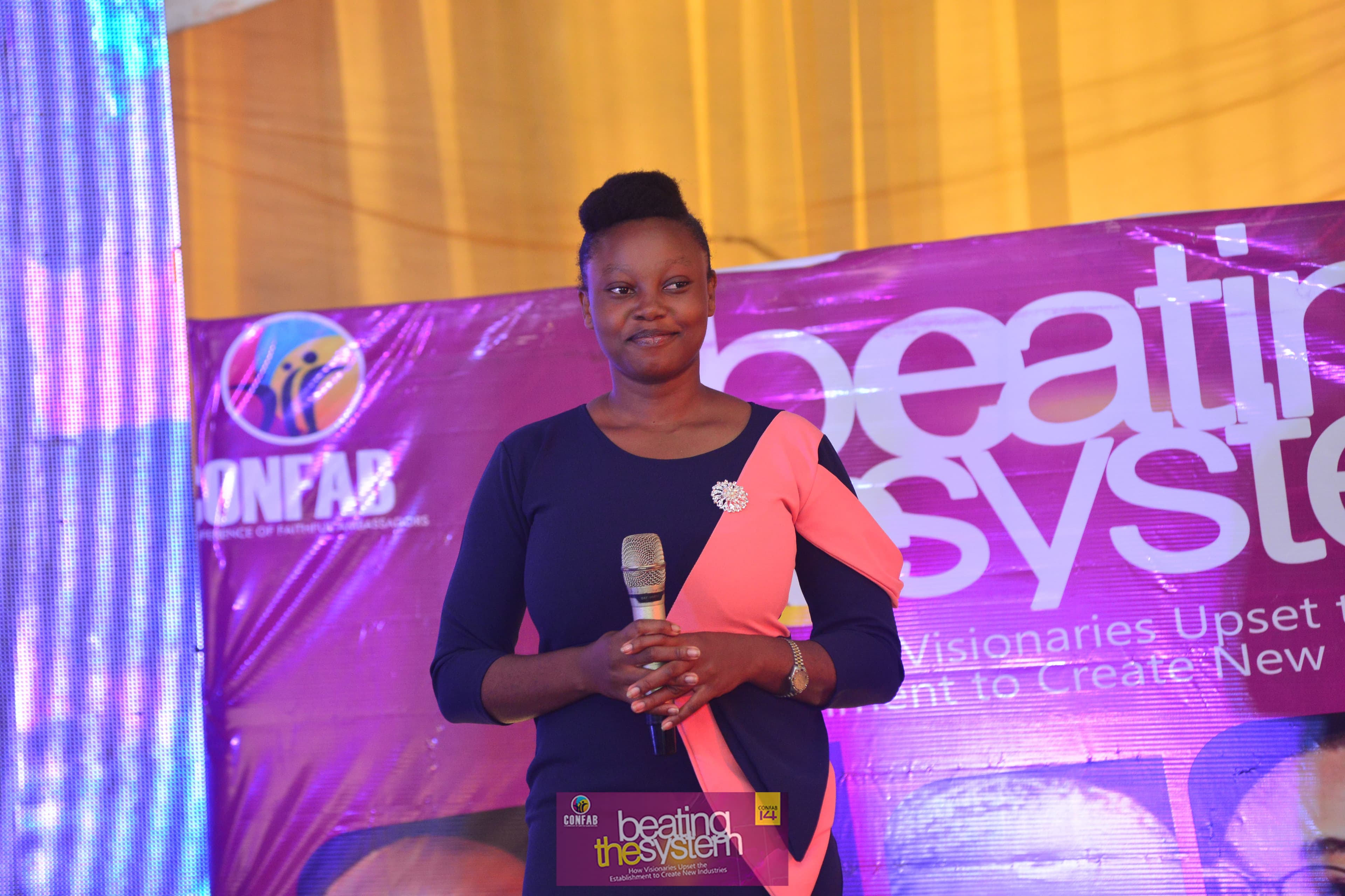 A woman speaking on the CONFAB stage